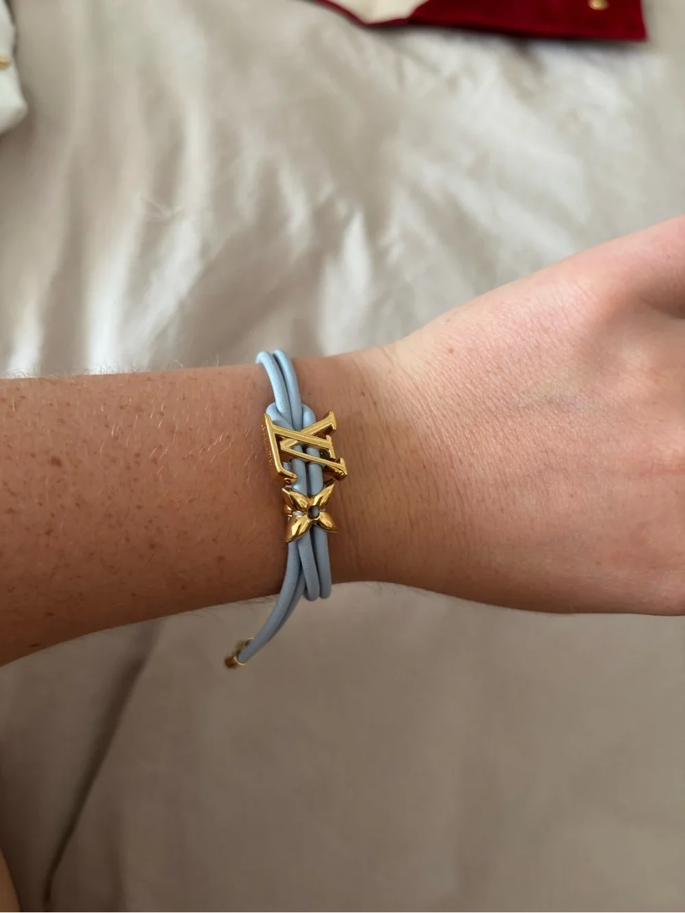 Louis Vuitton Light Blue Leather Cord Bracelet with Gold LV Charm